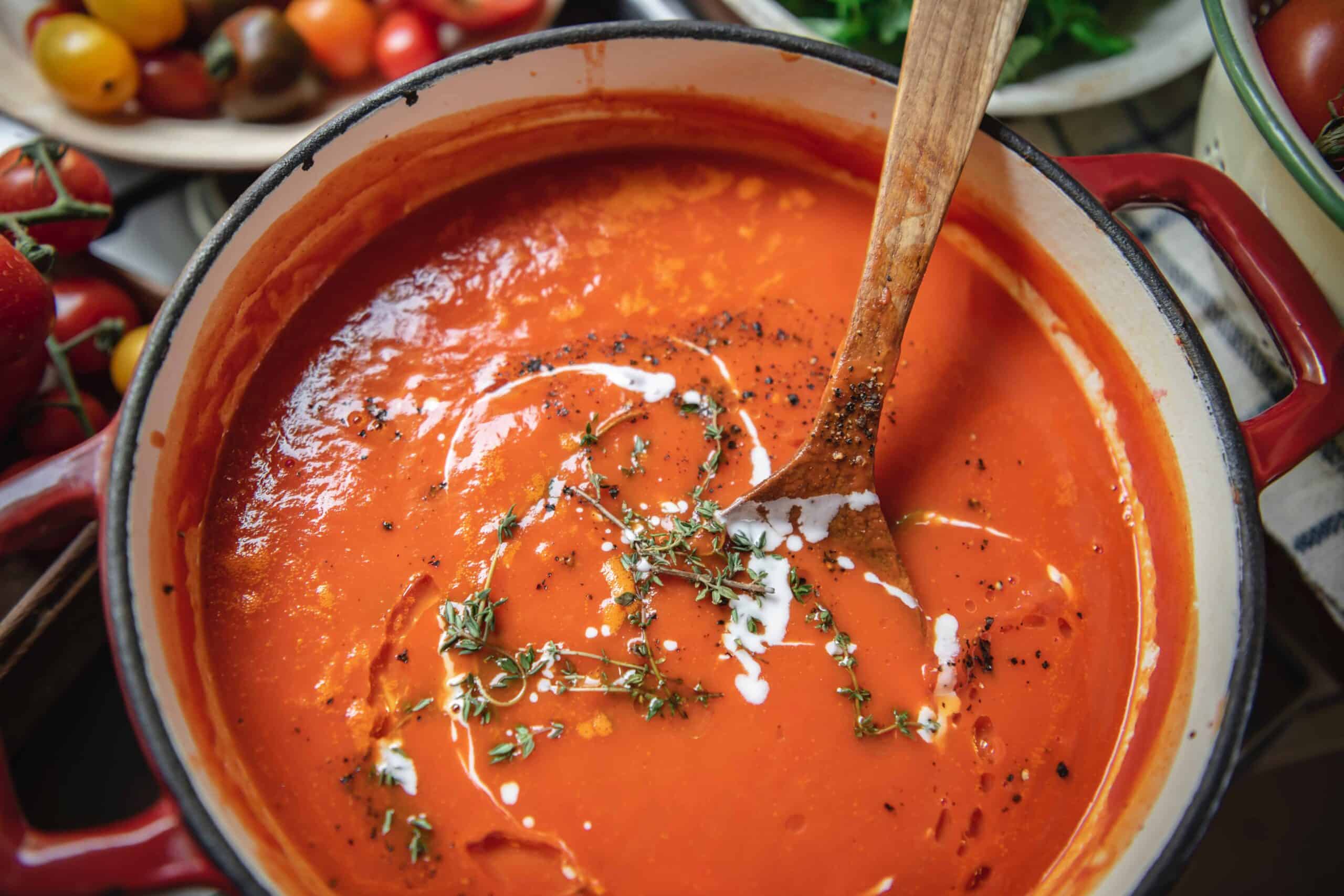 Tomato soup in a bowl with fresh herbs