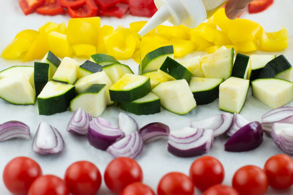 Drizzling garlic oil onto zucchini