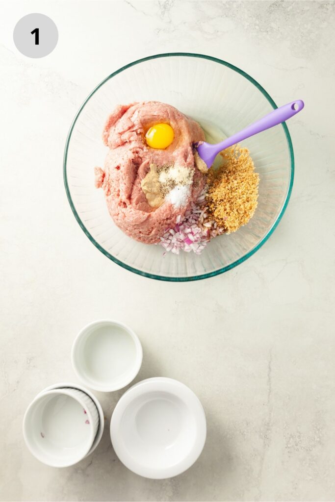 Mixing together the ground turkey mixture in a glass bowl