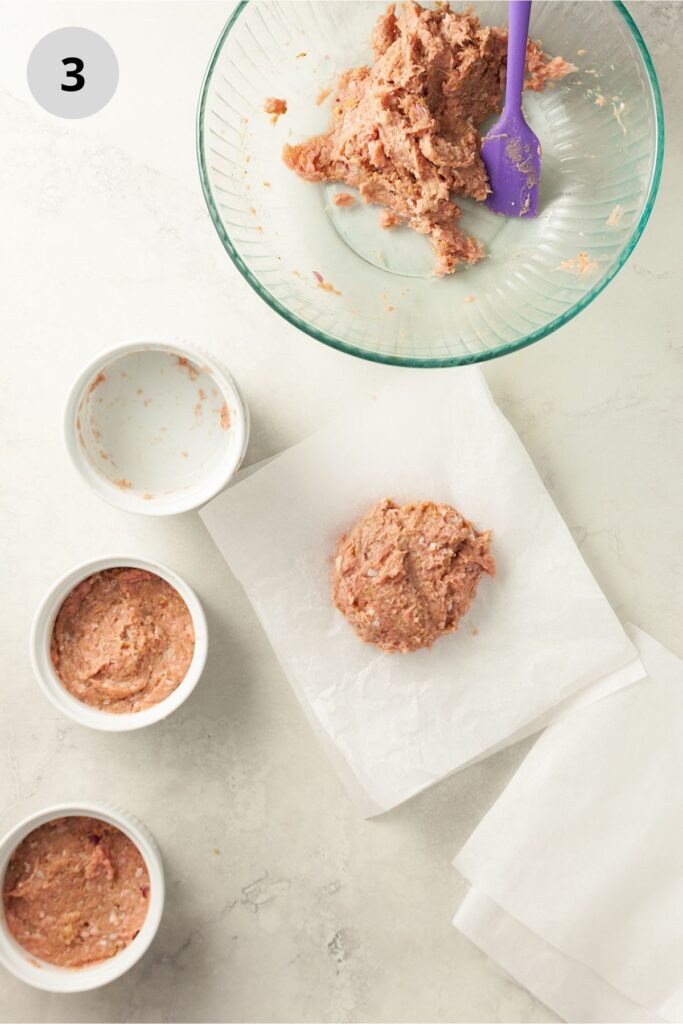 Placing turkey mince onto parchment paper