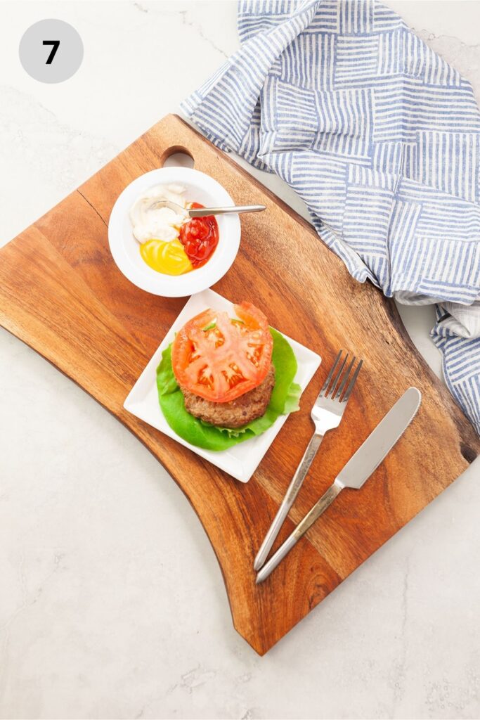 Adding lettuce and tomato to a turkey burger