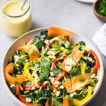 Curry stir fry with zucchini noodles in a white bowl