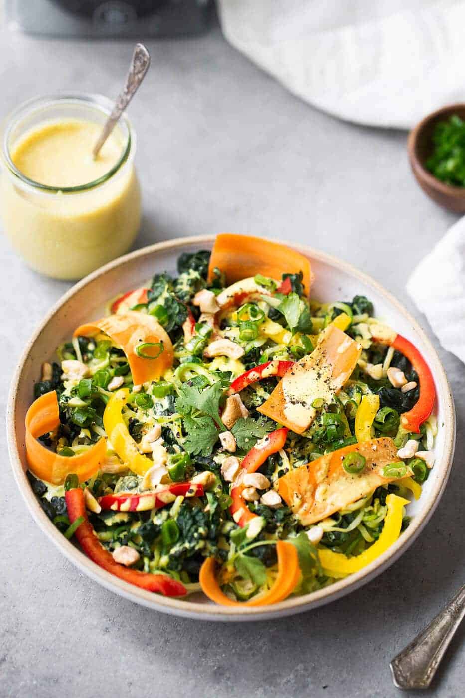 Curry stir fry with zucchini noodles in a white bowl