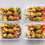 Variety of dishes prepped in four plastic containers