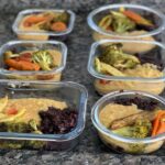 Meal prepped food stored in glass containers
