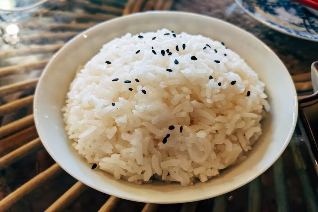 White rice sprinkled with black sesame seeds on a bowl