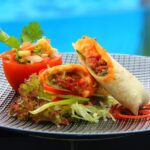A close-up view of Burritos placed on a ceramic plate