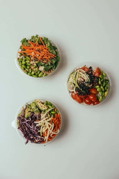 Three bowls filled with prepared vegetable meals