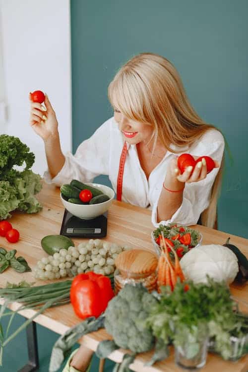 Woman using a scale to measure her vegetables