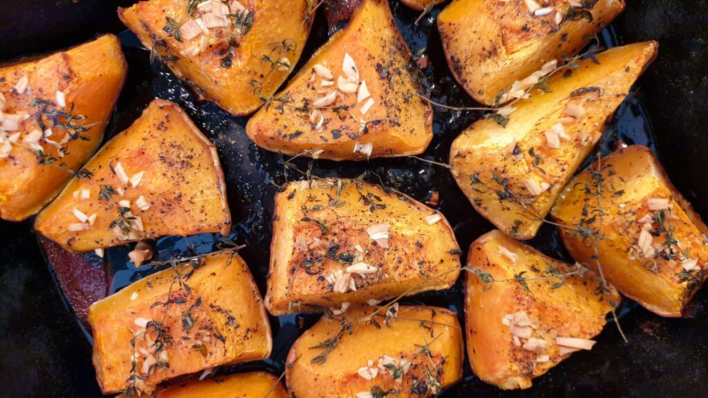 A golden brown air fried japanese sweet potato served with seasonings in a plate