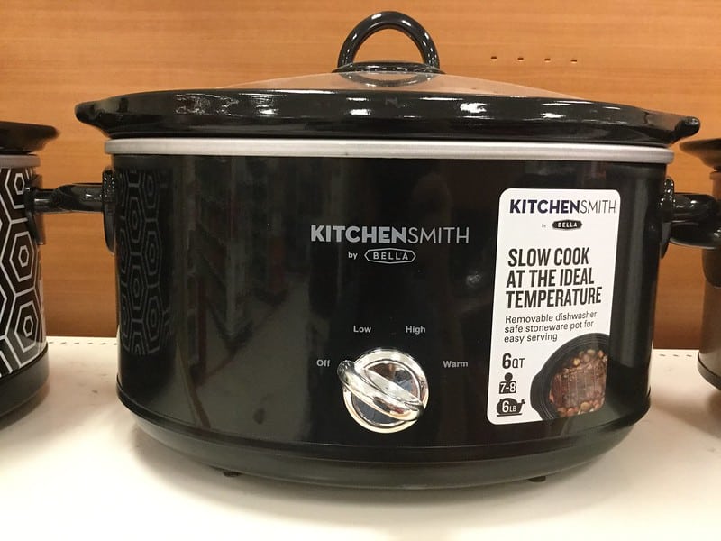 A black slow cooker placed in the kitchen