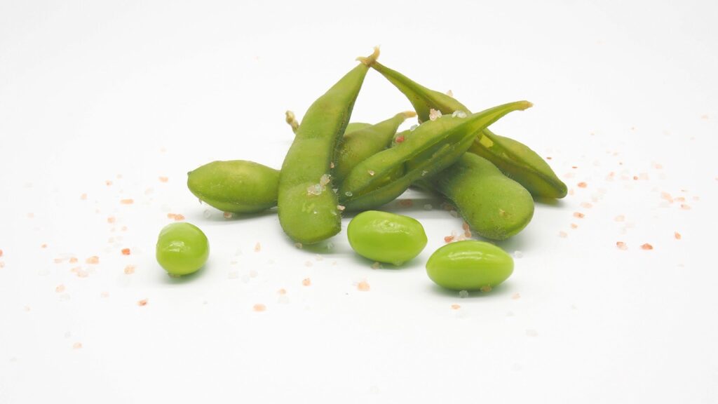 A bunch of seasoned green edamame on a table