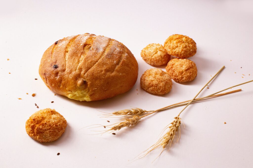 Two kinds of round bread with a grains on a white surface