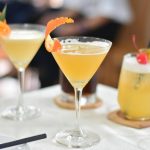 Three distinct drinks are placed on a table