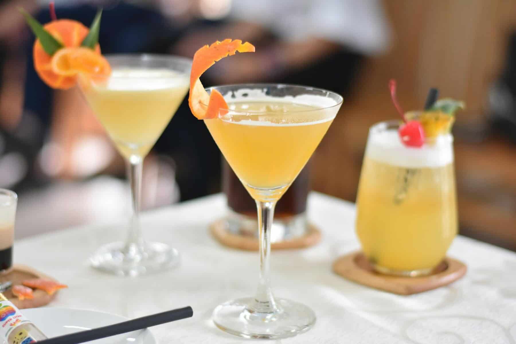 Three distinct drinks are placed on a table