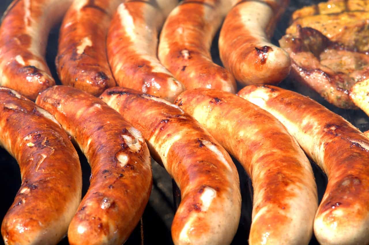 Lined up sausages being cooked