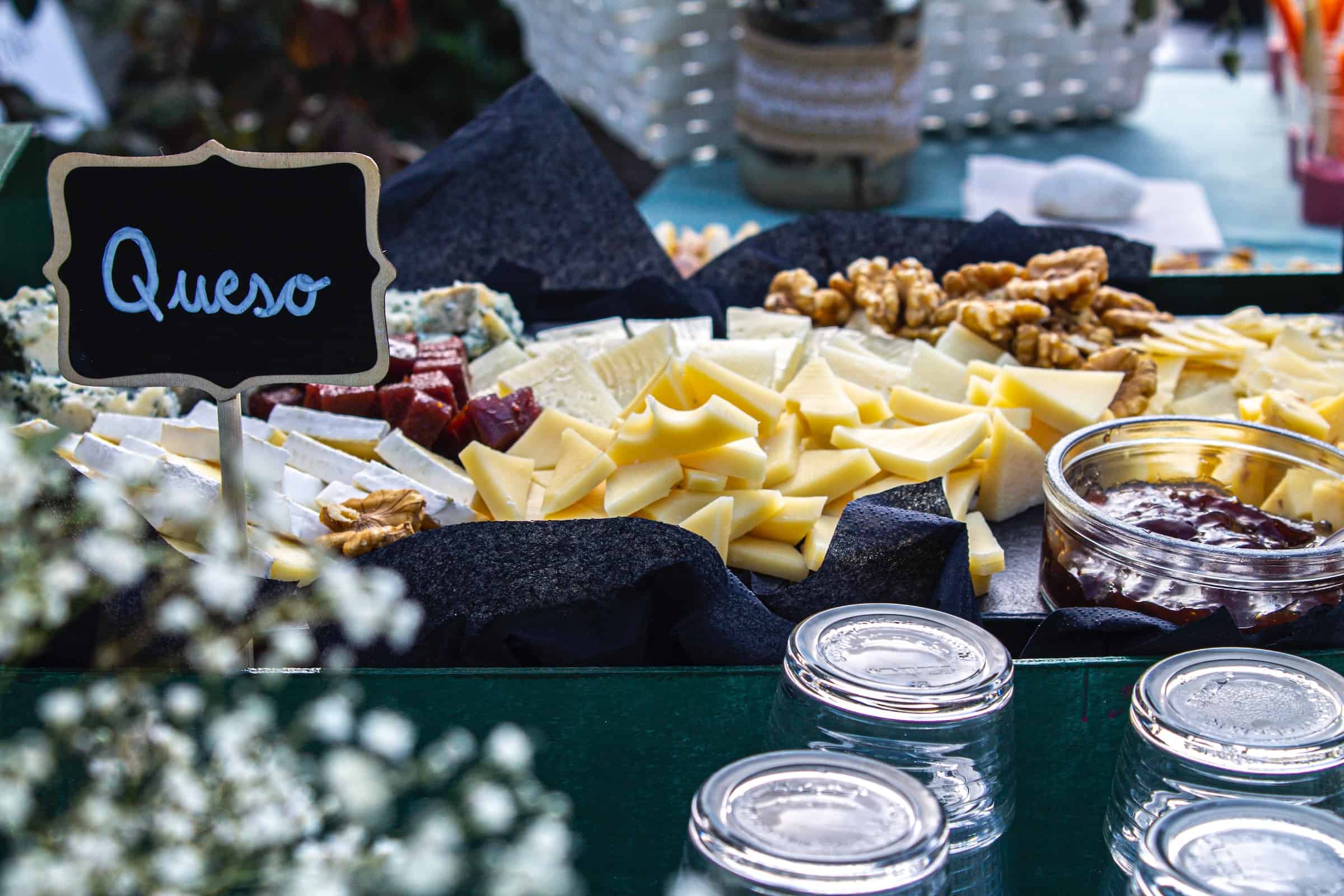 An image of cheese along with other foods in a table