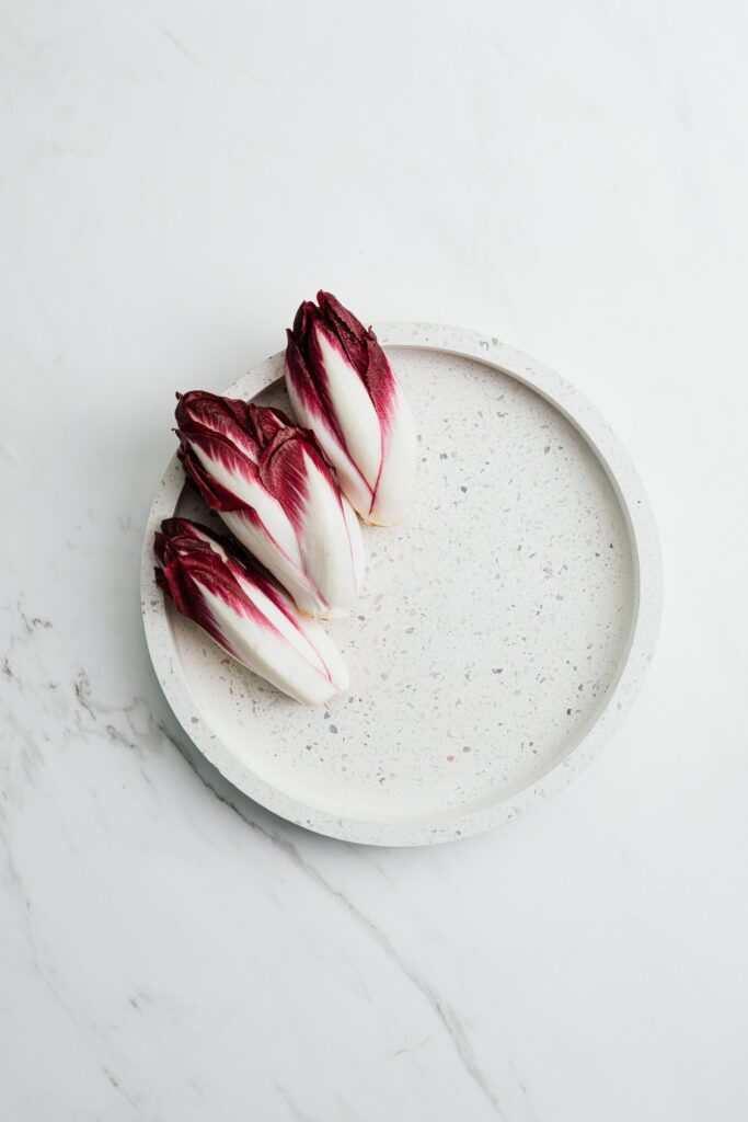 An image of  chicories on a white ceramic plate