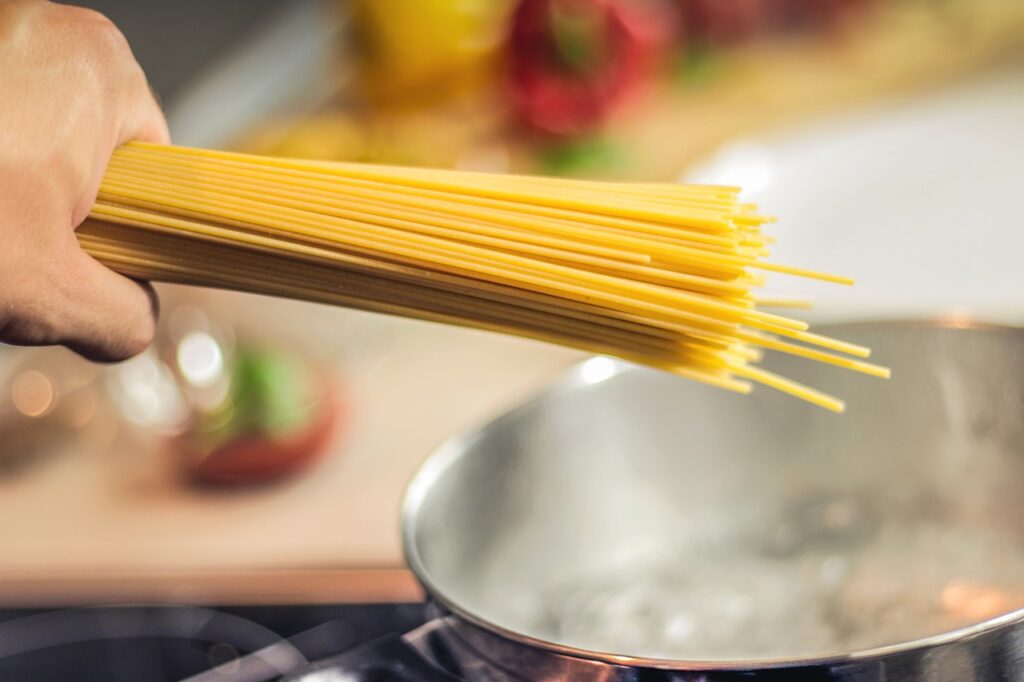 A regular pasta being put on boiling water