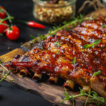 Rack of barbeque spare ribs placed on a wooden rack