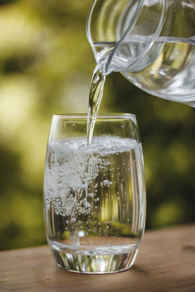 Water being poured from a pitcher to a glass