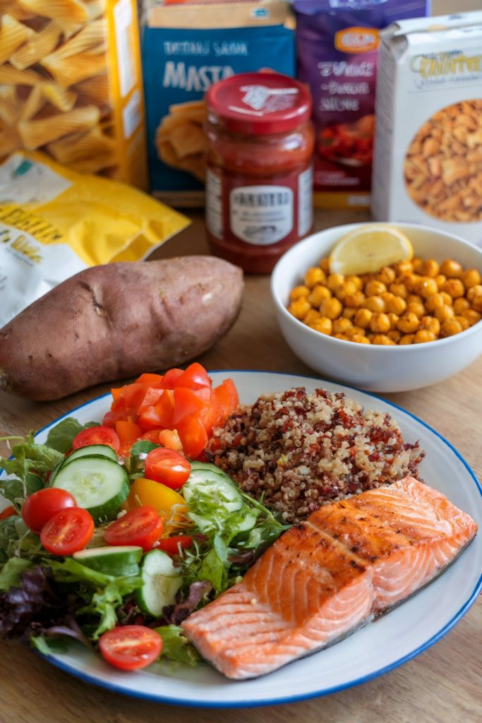 A healthy salad on a bowl while there are some packaged foods on the background