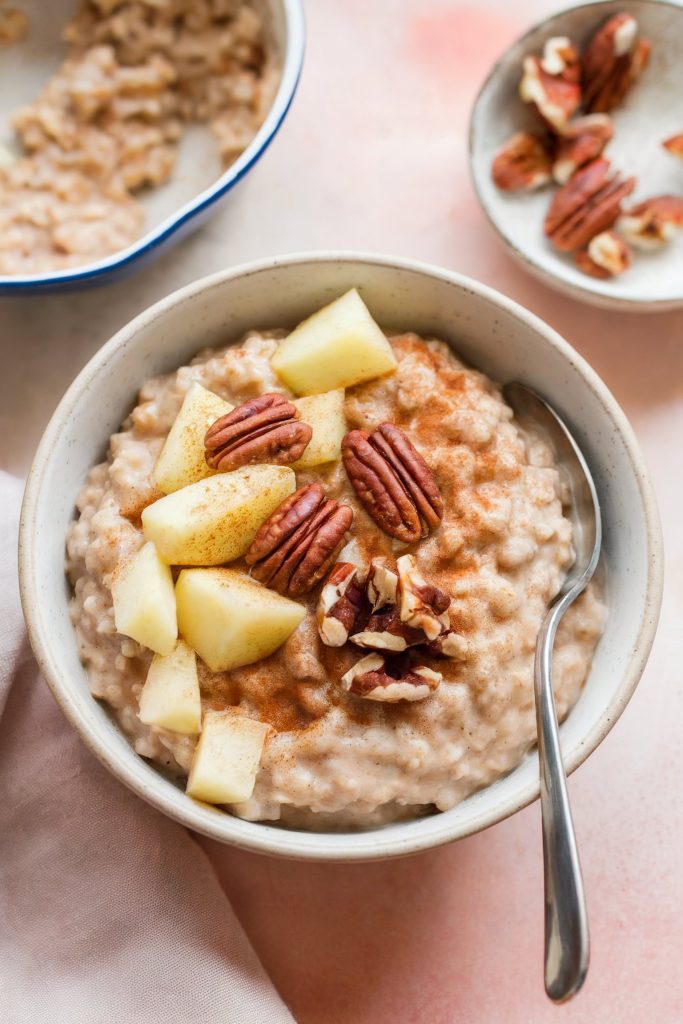 Apple cinnamon oatmeal on a bowl with a spoon