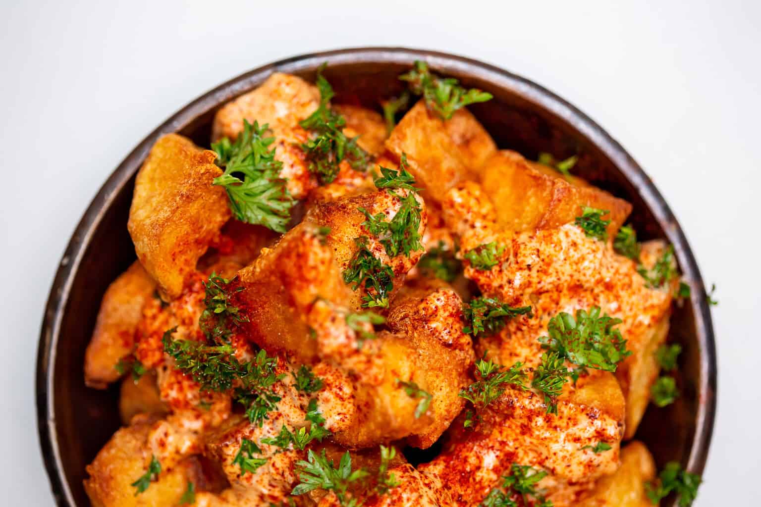 Crispy roasted potato wedges sprinkled with paprika and parsley