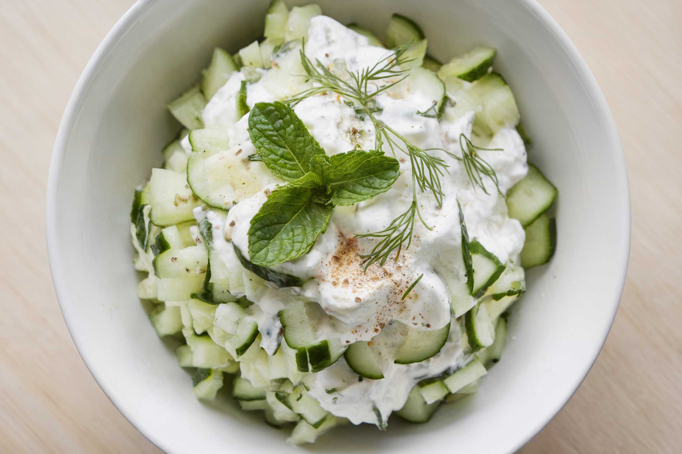 Cucumber yogurt salad (cacik) in a white bowl