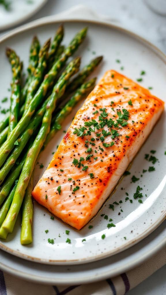 Plate of baked salmon with asparagus garnished with parsley.