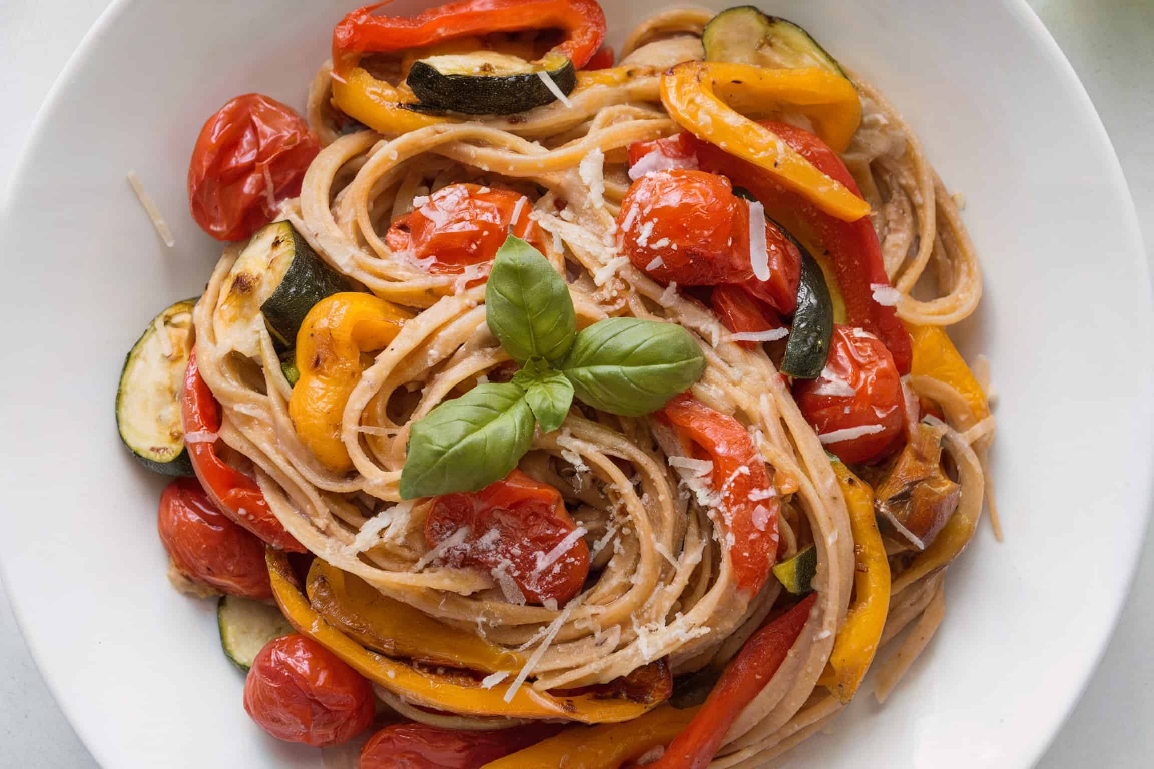 Whole wheat pasta primavera on a white plate
