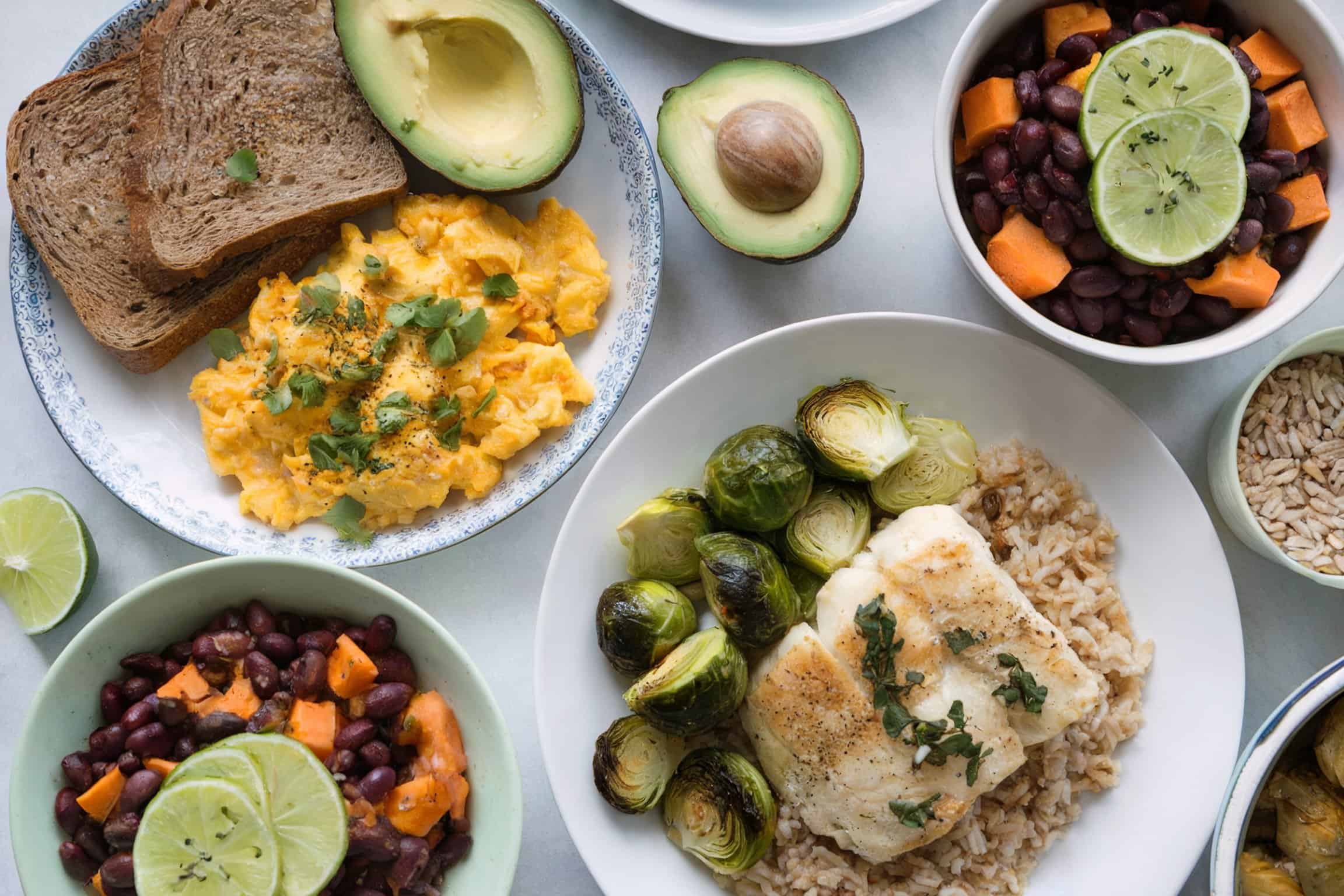 A breakfast, lunch, and dinner spread with a variety of healthy dishes