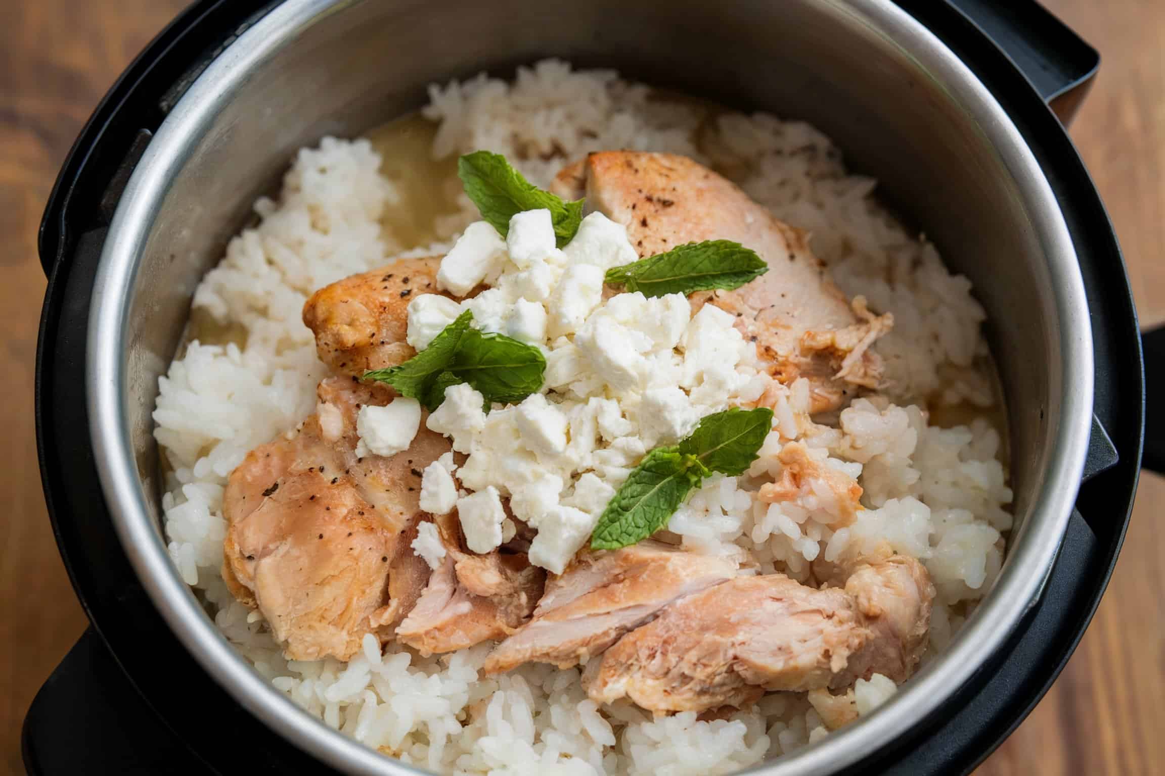 A rice cooker with chicken and rice