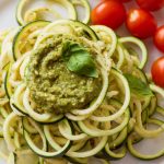 A plate of zucchini noodles tossed with pesto.