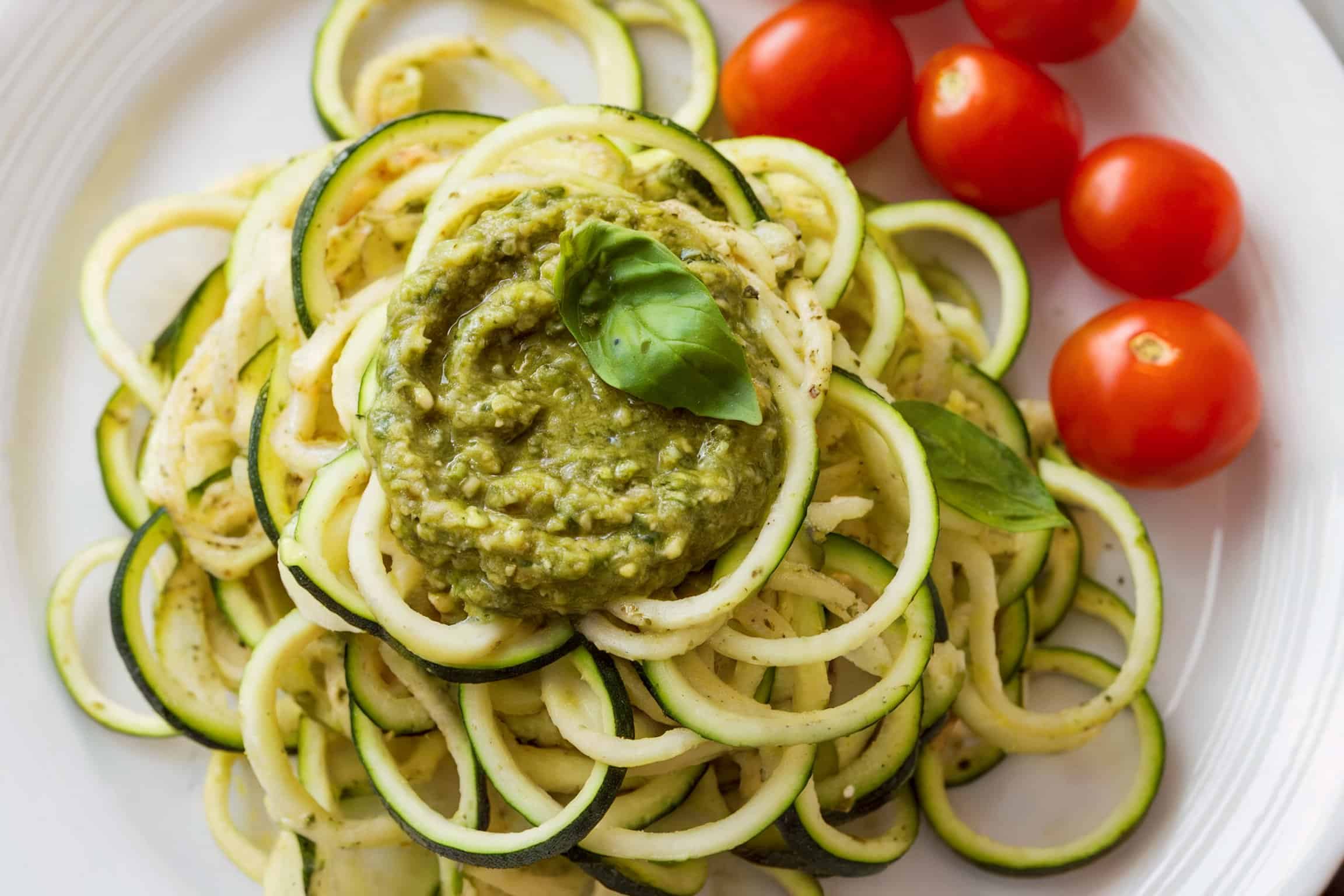 A plate of zucchini noodles tossed with pesto.