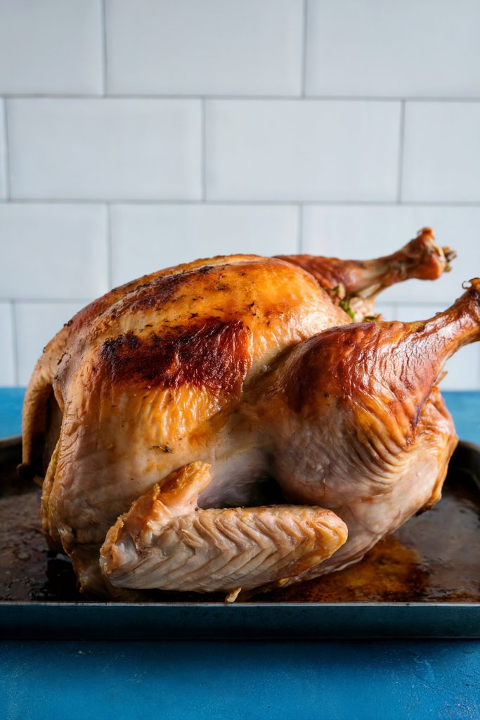 A whole beautifully cooked turkey on a kitchen countertop