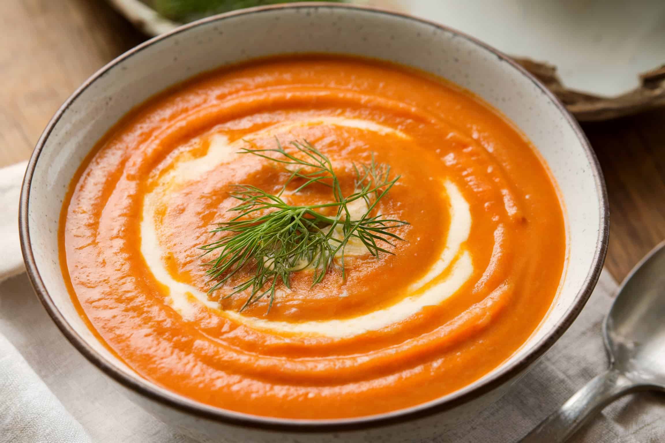 A creamy carrot fennel soup with a sprinkle of fresh dill on top
