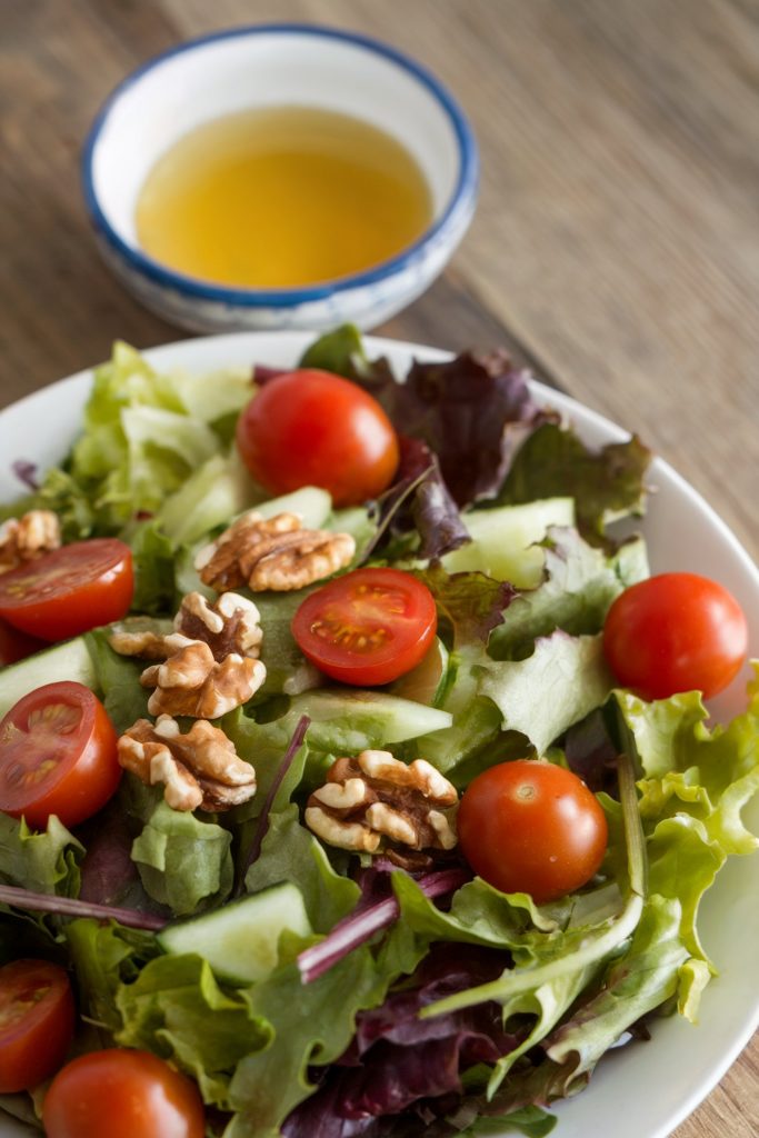 Apple Cider Vinegar beside a salad