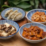 Four Chinese dishes on separate bowls