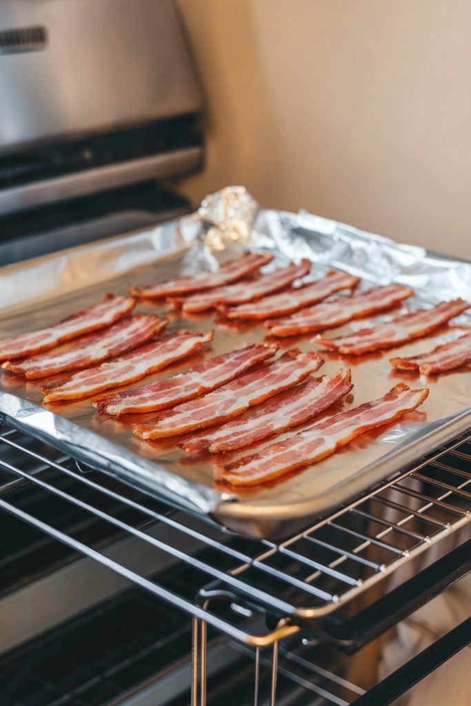 Bacon strips placed on a baking foil