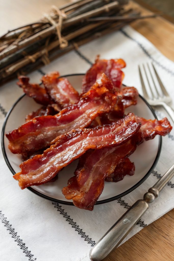 Glazed bacon strips on a plate