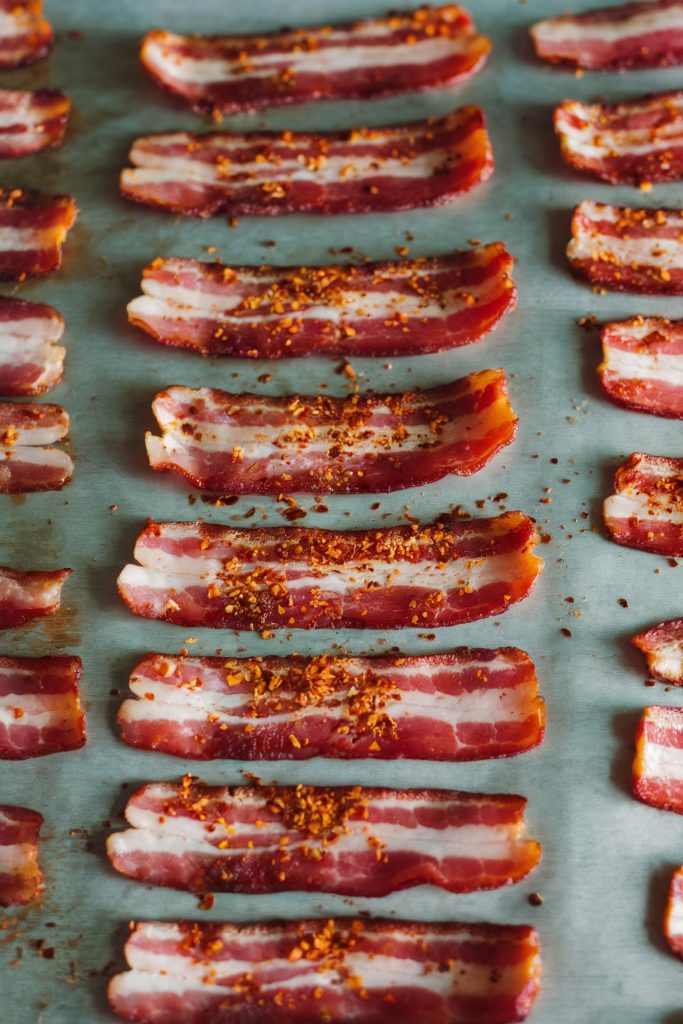 Uncooked bacon with chili flakes
