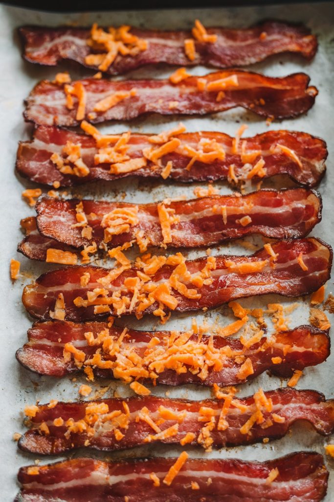 Baked bacon sprinkled with cheese
