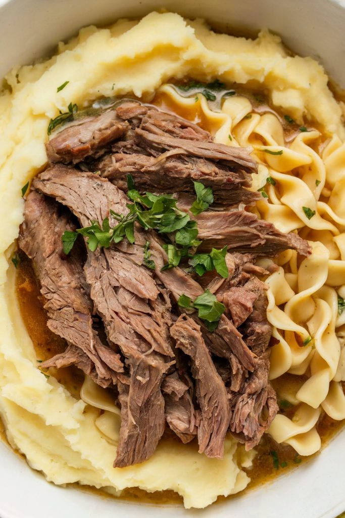 Beef and Noodles over Mashed Potatoes