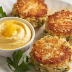 Golden brown crab cakes on a white plate