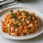 A golden-brown, crumbly dish on a white plate